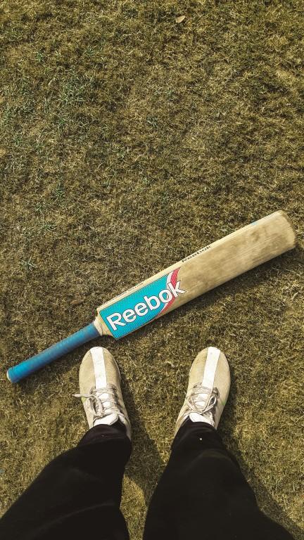 Cricketer batting on the pitch